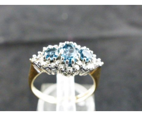 9ct gold fancy blue topaz and diamond cluster ring. Size J/K