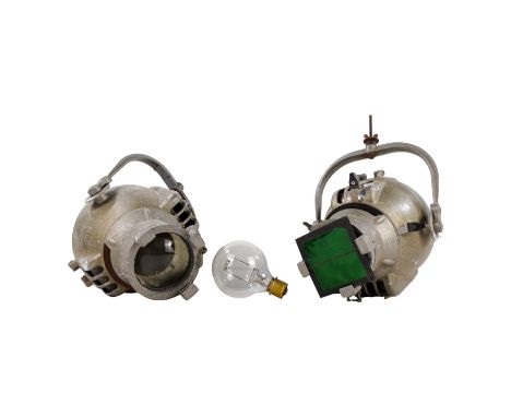 Two Strand Electric cast metal theatre lights - together with an early light bulb.
