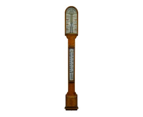 An early 20th century oak stick barometer - by J H Steward  of London, with a pair of vernier scales and incorporating a ther