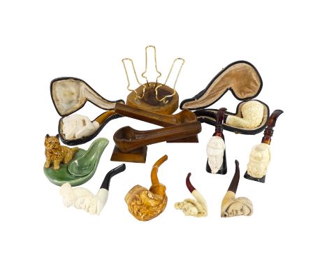 A late 19th century meerschaum pipe - the bowl modelled as the green man, with a amber stem, together with seven further meer
