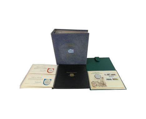 International Society of Postmasters commemorative album - containing First Day Covers mounted with a sterling silver coin, t