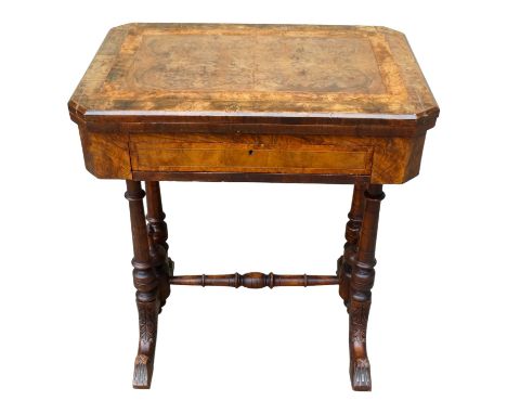 A Victorian walnut games and work table - the hinged rectangular top with canted corners opening to reveal chess and backgamm