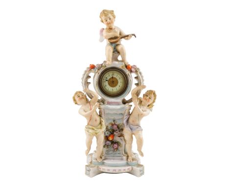 An early 20th century German porcelain mantel clock - modelled with three cherubs about a central movement with ivorine dial 