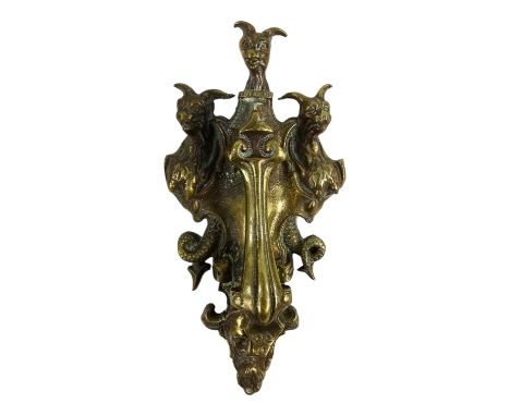 A late 19th century brass door knocker - cast with dragons, foliate scrolls and a green man mask, height 29cm