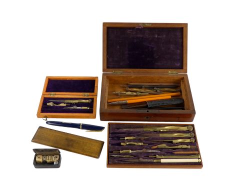 An early 20th century cased drawing set - fitted with brass instruments with a lift-out tray including pens etc. below, toget