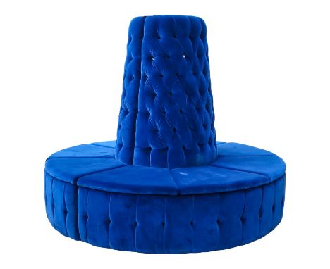 A contemporary vivid blue velvet button upholstered circular bench - with a central tapering back and segmented cushion seats