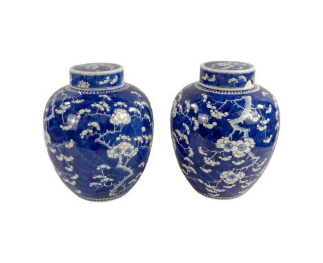 A pair of late 19th century Chinese Kangxi blue and white ginger jars - with covers, with prunus decoration, height 30cm. (2)