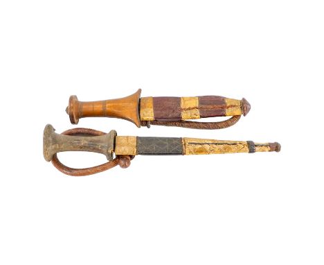 A 19th century middle eastern dagger - with hardwood handle, ridged blade and leather scabbard, together with another similar