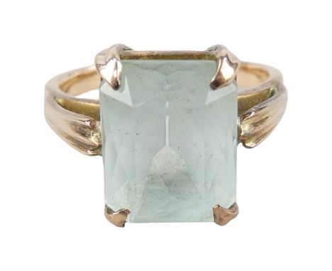 A 15ct gold ring - claw set with an emerald cut light blue stone, size O, weight 4.8g.