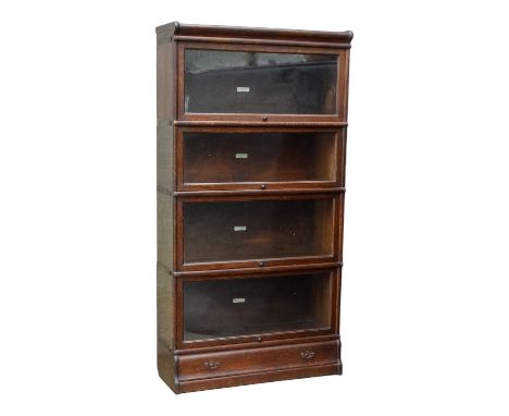 An oak Globe Wernicke sectional bookcase - comprising four sections raised on a base, 87cm x 31cmx 166cm