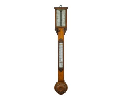 An early 20th century oak stick barometer - with a pair of vernier scales and incorporating a thermometer and leaf carved cis
