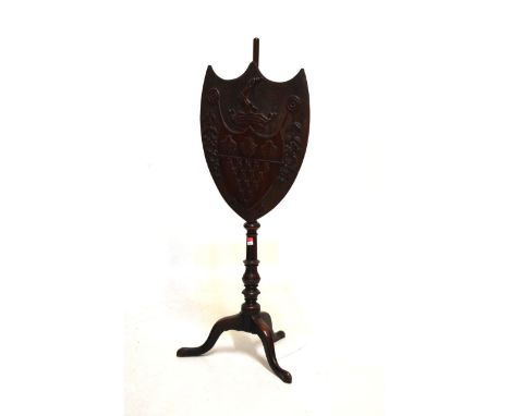Unusual 19th Century carved mahogany and fruitwood armorial firescreen, the adjustable shield-shaped screen with crest and st