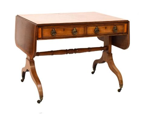 19th Century satinwood crossbanded mahogany sofa table, with two drawers on twin end standards and brass square caps with cas