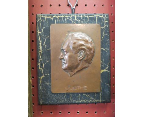 A copper plaque mounted on a wooden base depicting a side portrait of "Goethe", 18cm x 14cm