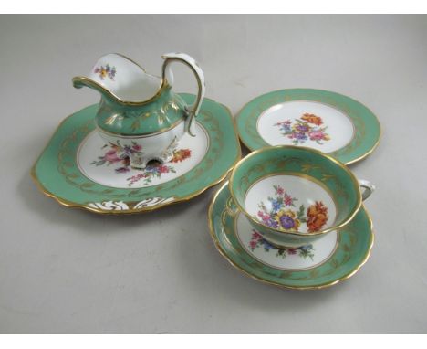 A circa 1900 Coalport style tea service with green banded border and handpainted floral detail, gilt embellishment 