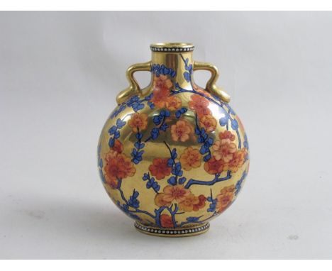 A 19th Century English porcelain moon flask with small handles, decorated with blossoms on gold ground, 15cm tall 