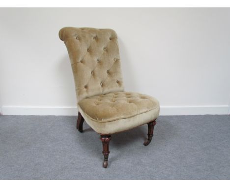 A circa 1860 walnut deep buttoned open armchair, the scroll back over a bow front seat on melon fluted and reeded tapering le