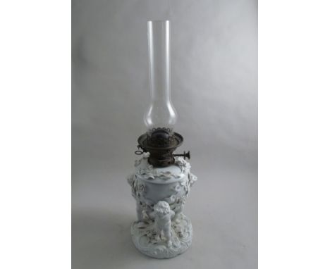 A late 19th early 20th Century porcelain oil lamp held loft by Putti, blue cross mark to base, 57cm tall