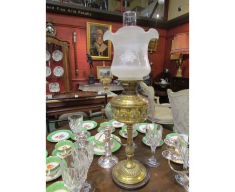 A Hinks Duplex No. 2, brass embossed oil lamp on circular base, clear and frosted glass shade with frilled rim, 69cm tall 