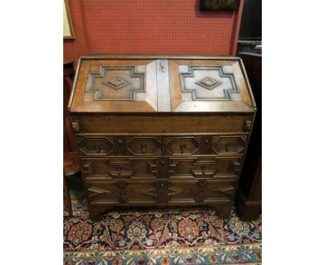 A late 17th / early 18th Century oak bureau, geometric mouldings, on bracket feet