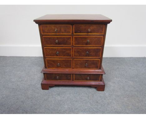 A Georgian style walnut miniature chest on stand on bracket feet, 33cm tall