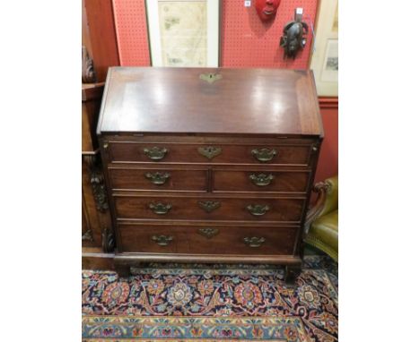 A Georgian mahogany bureau with fitted shaped interior, secret drawers, bracket feet a/f 