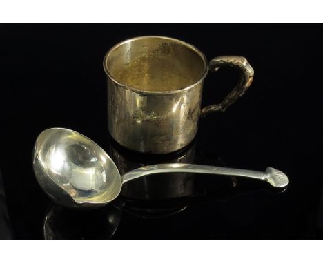 A sterling silver sauce ladle with shell form terminal, and a sterling silver christening mug (2)