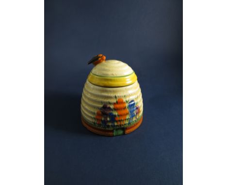 A Clarice Cliff "Crocus" pattern honey pot, surmounted by bee (slight chip to wing), 9cm tall