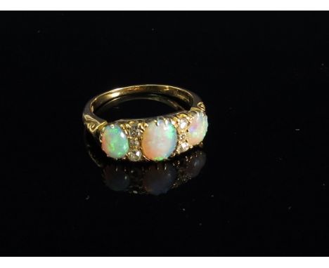 An 18ct gold three stone opal and diamond ring