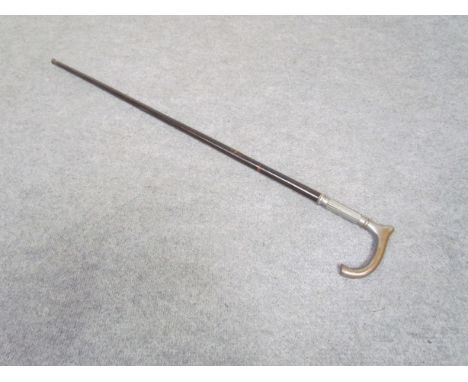 An ebonised walking stick with metal handle