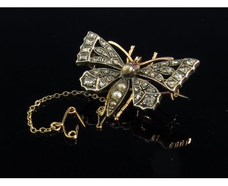 A Victorian butterfly brooch with old cut diamond encrusted wings, ruby set eyes and pearl set thorax in fitted case, T & J P