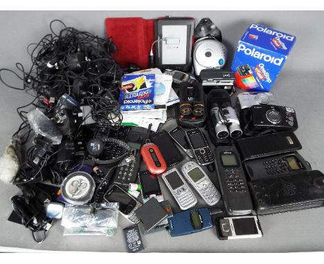 A collection of cameras, vintage mobile phones and chargers.