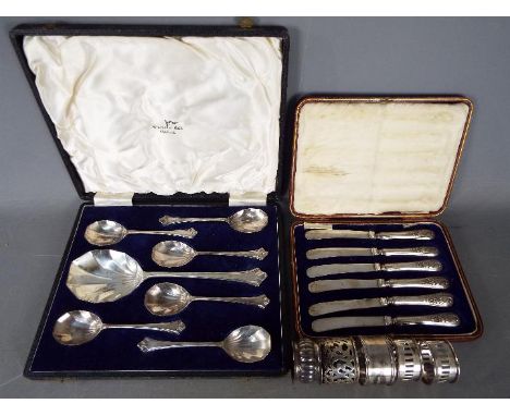 A cased set of George V silver handled butter knives, Sheffield assay 1911, a silver plated dessert spoon set, also cased, th