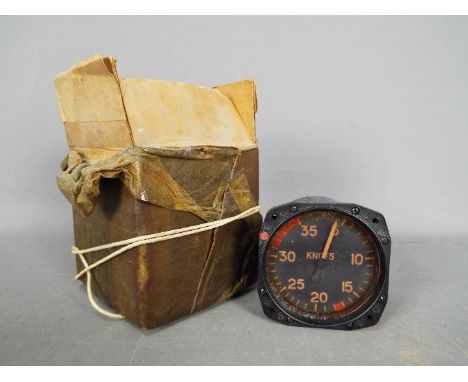 A vintage air speed indicator gauge with box marked 'Lancaster X Spares'
