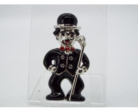 Butler & Wilson - a Butler & Wilson enamel and stone set brooch in the form of Charlie Chaplin, verso displaying Butler & Wil