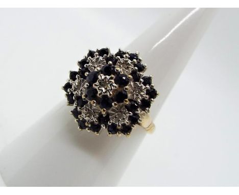 A 9ct gold and sapphire cluster ring, size O, approximately 3.8 grams all in.