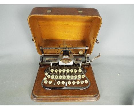 An early 20th century, aluminium 'Featherweight' Blickensderfer typewriter in carry case.