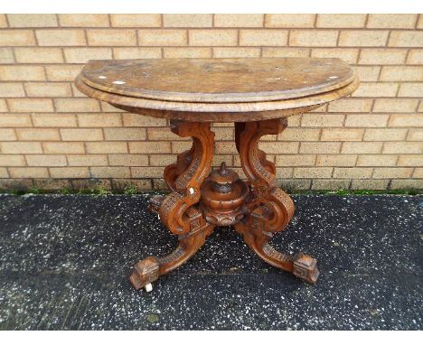 A demilune, fold over card table on highly carved, castored, base, approximately 75 cm (h) and 110 (d)