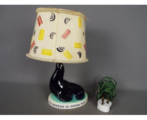 Breweriana - A Guinness advertising table lamp by Carlton Ware modelled as a sealion, base reads 'Guinness Is Good For You', 