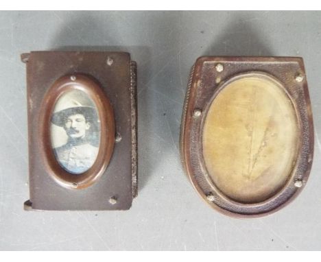 Two bakelite vesta cases / match safes comprising one of standard form with inset image of Baden Powell, the other of horsesh