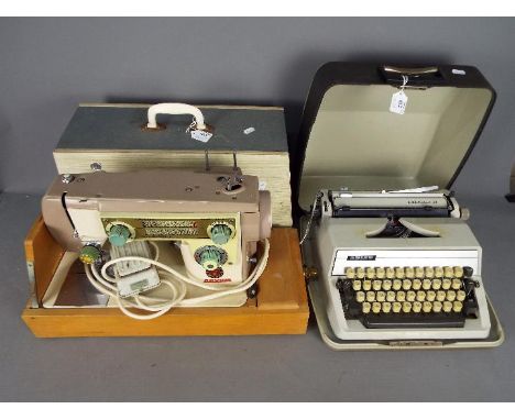 A vintage Novum Deluxe Mark X electric sewing machine in carry case and an Adler Gabriele 25 typewriter. [2]