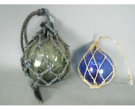 A vintage glass fisherman's float, approximately 13 cm (d) and one other of smaller proportion. [2]