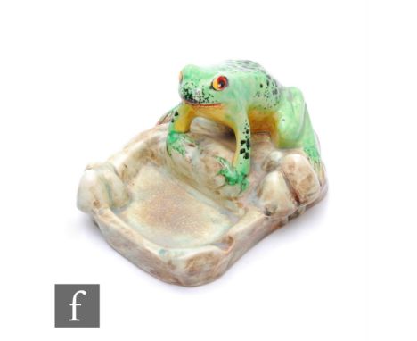 E. Radford - A 1930s novelty ashtray modelled as a seated frog on a rock with hand enamelled decoration, printed signature, h