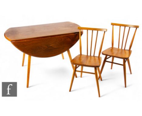 Ercol - A mid century teak drop leaf table, raised on splayed angular legs, height 71cm, extended diameter 123cm, together wi
