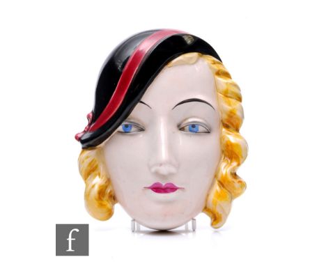 Goebel - An Art Deco ceramic wall mask, modelled as a lady with blonde curls and wearing black hat with burgundy band, impres