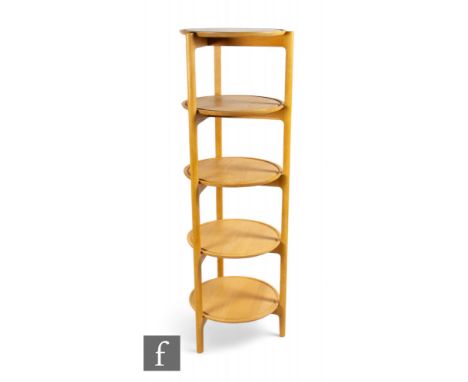 Ercol - A 'Svelto' open circular shelving unit, the beech frame with five circular shelves, height 144cm, diameter 44cm.