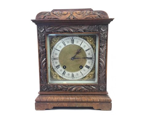 LATE 19TH CENTURY CARVED WALNUT BRACKET CLOCK,with chiming movement and gilt dial with silvered chapter ring, 32cm high