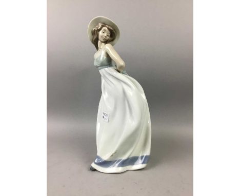 NAO FIGURE,modelled as a female standing with hat, 33cm high, along with another figure (2)
