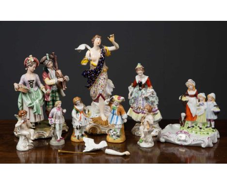 A group of ceramic figurines comprising a Derby style angel, 30cm high; a Royal Vienna figurine of a wealthy lady, 21cm high;