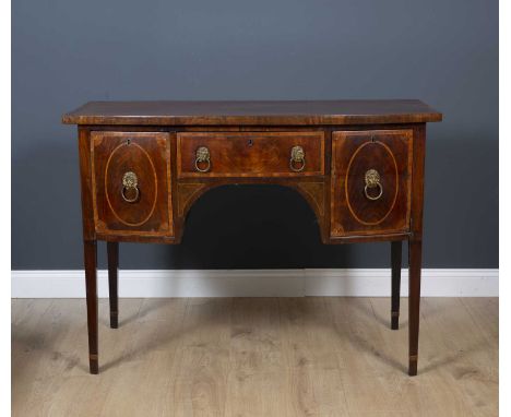 A George III mahogany and stainwood inlaid bow fronted sideboard with brass lions ring handles and square tapering legs, 122.